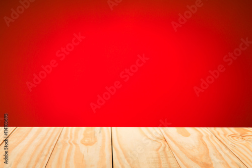 Wood table top on abstract gradient red background