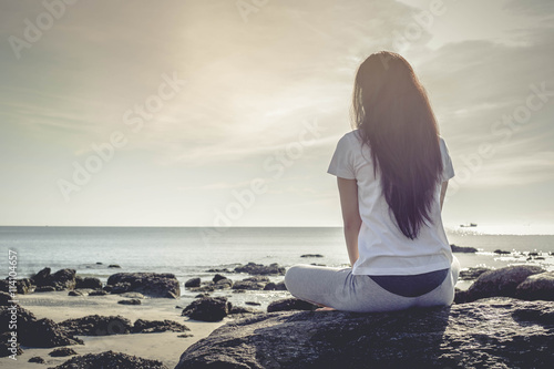meditating woman at beach