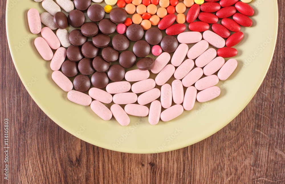 Colorful medical pills, tablets and capsules on plate, health care concept Colorful medical pills, tablets and capsules on plate, health care concept
