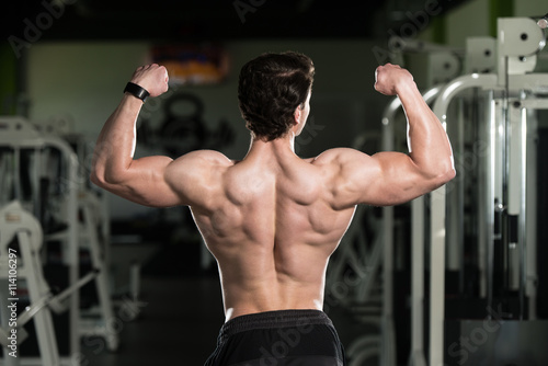Young Bodybuilder Flexing Rear Double Biceps Pose