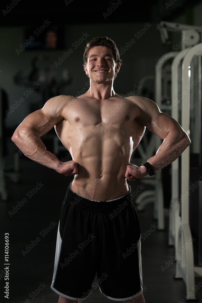 Bodybuilder Performing Front Lat Spread Pose Bodybuilder Performing Front Lat Spread Pose