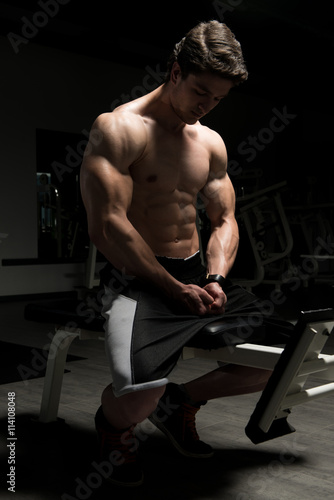 Muscular Man Resting On Bench After Exercise