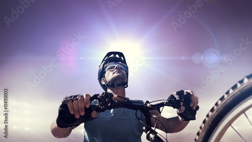 Fototapeta Naklejka Na Ścianę i Meble -  Composite image of man cycling with mountain bike
