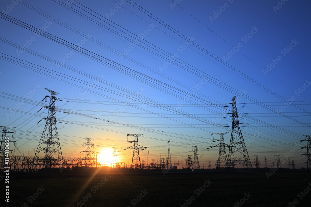 The silhouette of the evening electricity transmission pylon