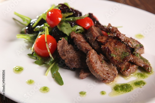 juicy meat with pesto and salad