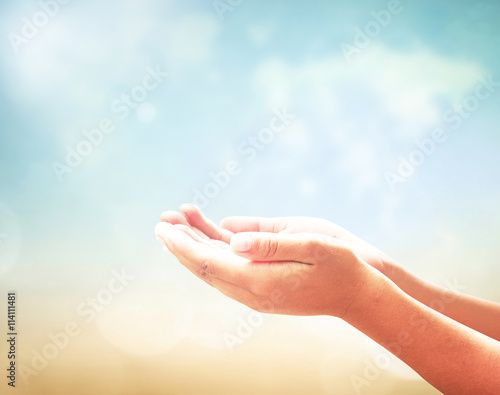 World environment day concept: Prayer open two empty hands with palms up for praying over world map of clouds background