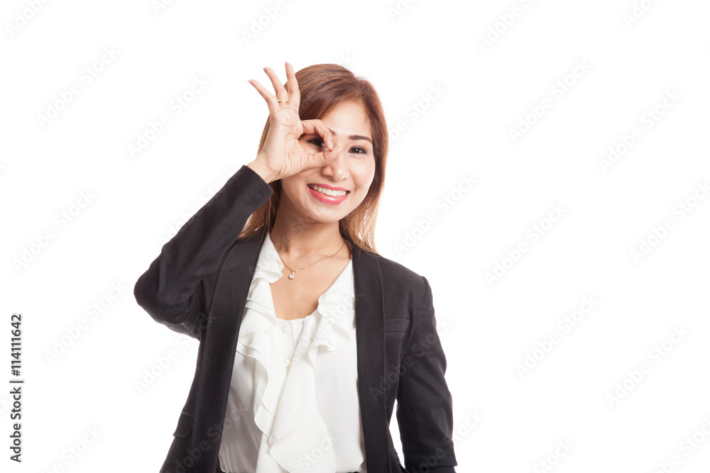 Beautiful young Asian woman show OK sign over her eye Beautiful young Asian woman show OK sign over her eye