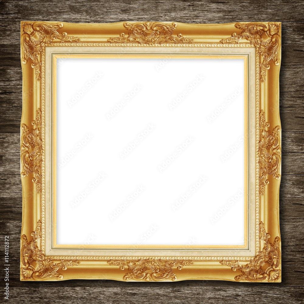 Antique gold frame on wooden wall background Antique gold frame on wooden wall background