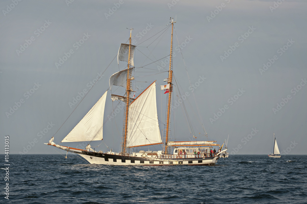 Tall Ship under sail with the shore in the background Tall Ship under sail with the shore in the background