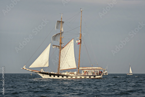 Tall Ship under sail with the shore in the background