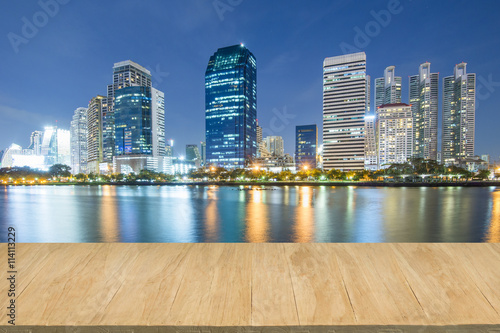 Wood floor with background of downtown city at night