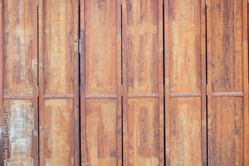 Door hinges are made of brown wood.