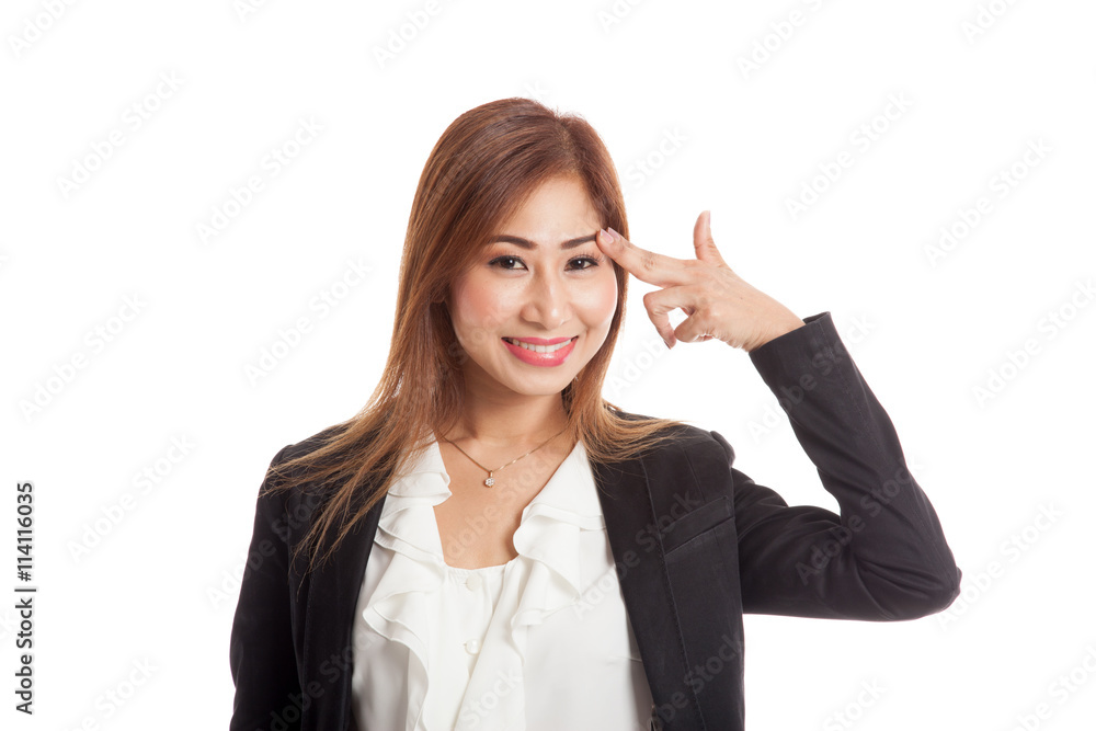 Beautiful young Asian woman holding fingers in gun gesture Beautiful young Asian woman holding fingers in gun gesture