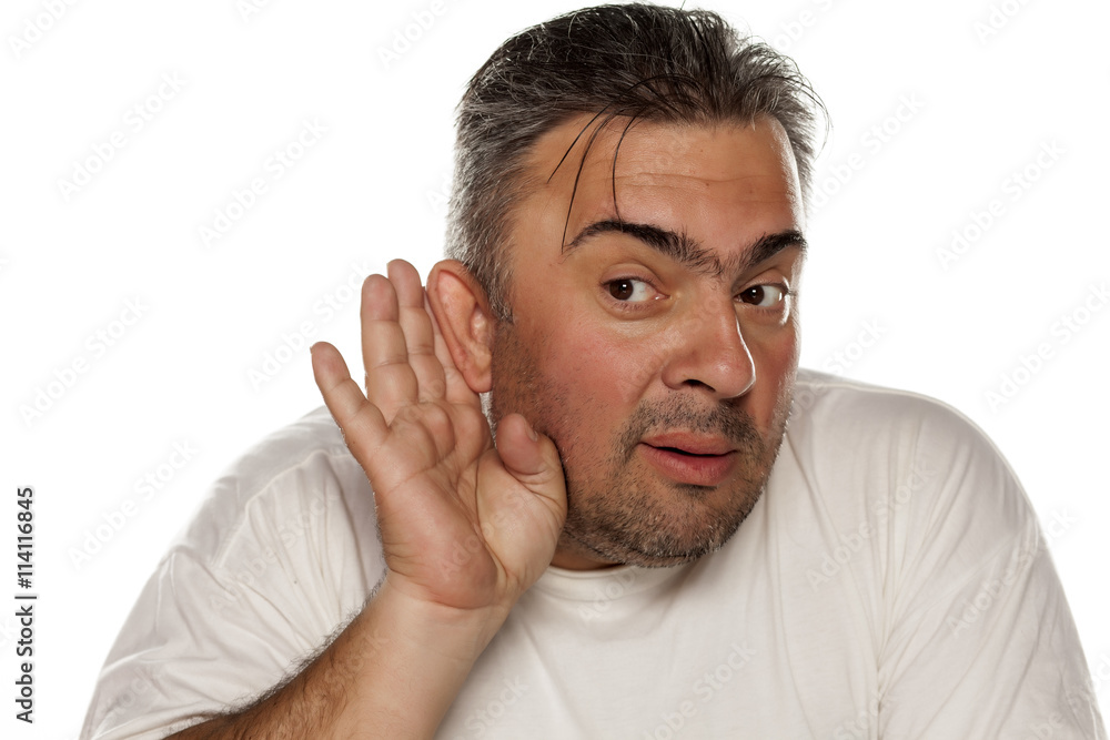 man holding his hands behind his ear and listen carefully man holding his hands behind his ear and listen carefully