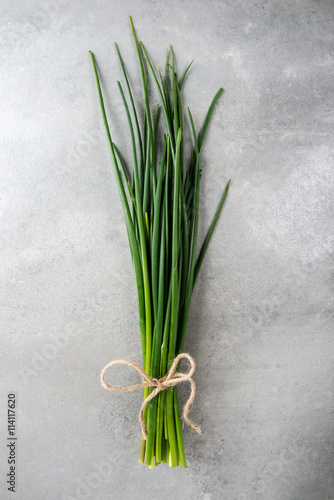 Fresh green chives on grey background