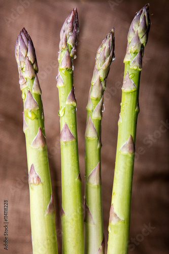 Raw green asparagus on wooden background