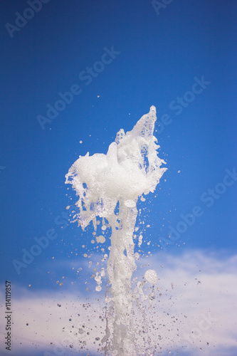 Water fountain water jet over blue sky