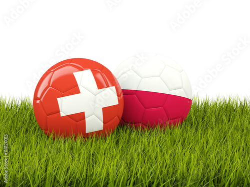 Switzerland and Poland soccer balls on grass