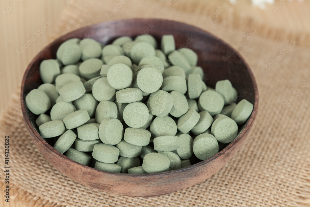 Herbal pill on wooden bowl. herb for healthy living. Herbal pill on wooden bowl. herb for healthy living.