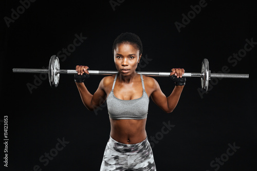Close-up portrait of a beautiful fitness woman with barbell