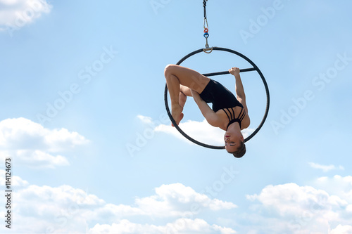 Sport woman doing exercises with a hoop, outdoors. 