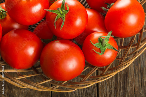 Canvas-taulu Tomatoes on wooden surface. Selective focus