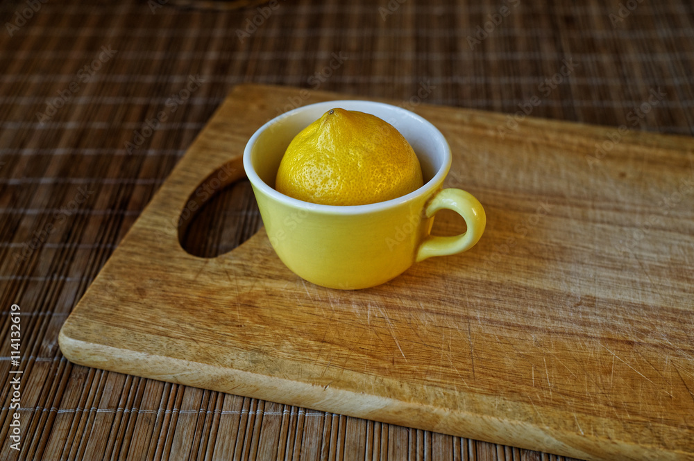 Lemon in a yellow cup. Lemon in a yellow cup.