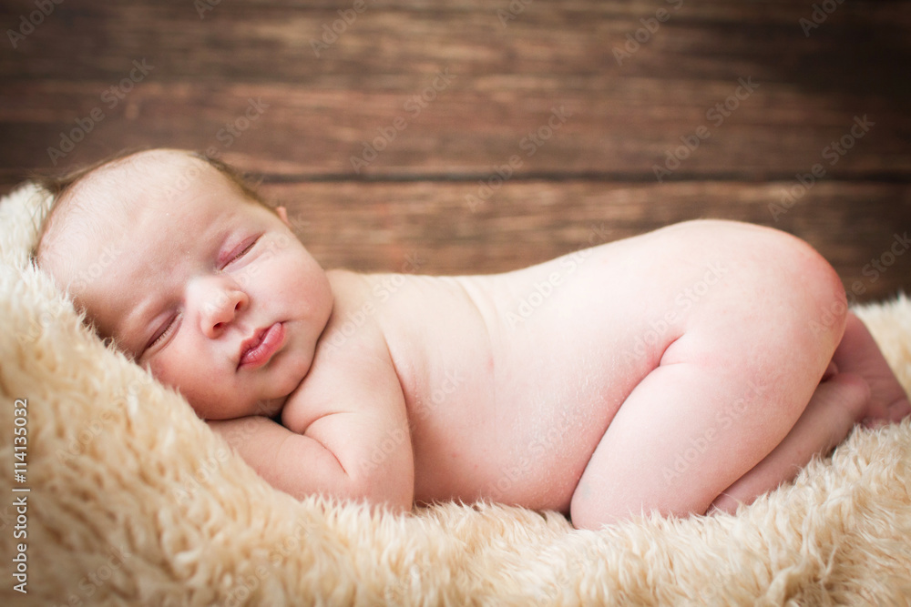 Newborn baby sleeping on a wooden background
Newborn baby sleeping on a wooden background