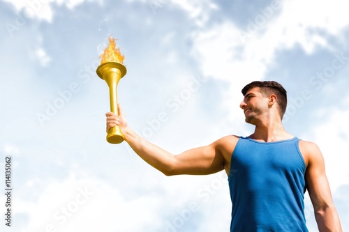 Composite image of low angle view of sportsman holding a cup 