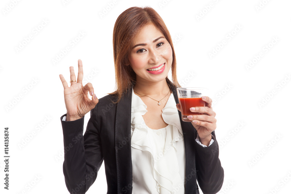 Young Asian business woman show OK with tomato juice Young Asian business woman show OK with tomato juice