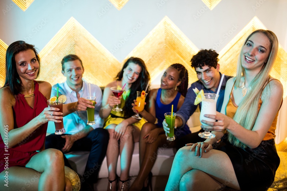 Obraz premium friends sitting on sofa and a glass of champagne