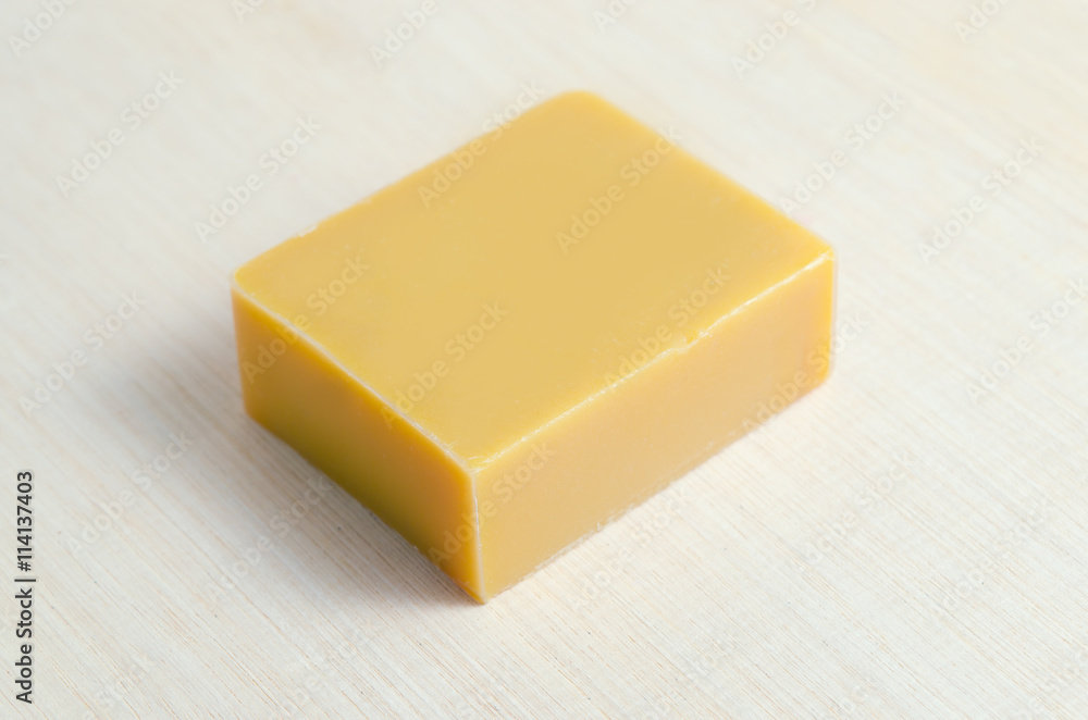 Soap bar flavor with mango ingredient isolated on wooden board b Soap bar flavor with mango ingredient isolated on wooden board b