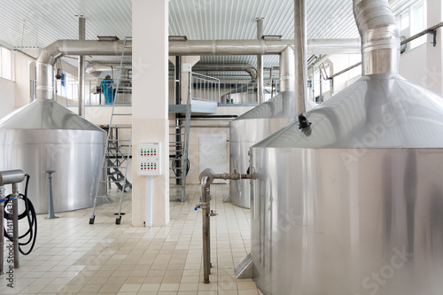 Tanks of beer in a small brewery. Brewing production - mash vats