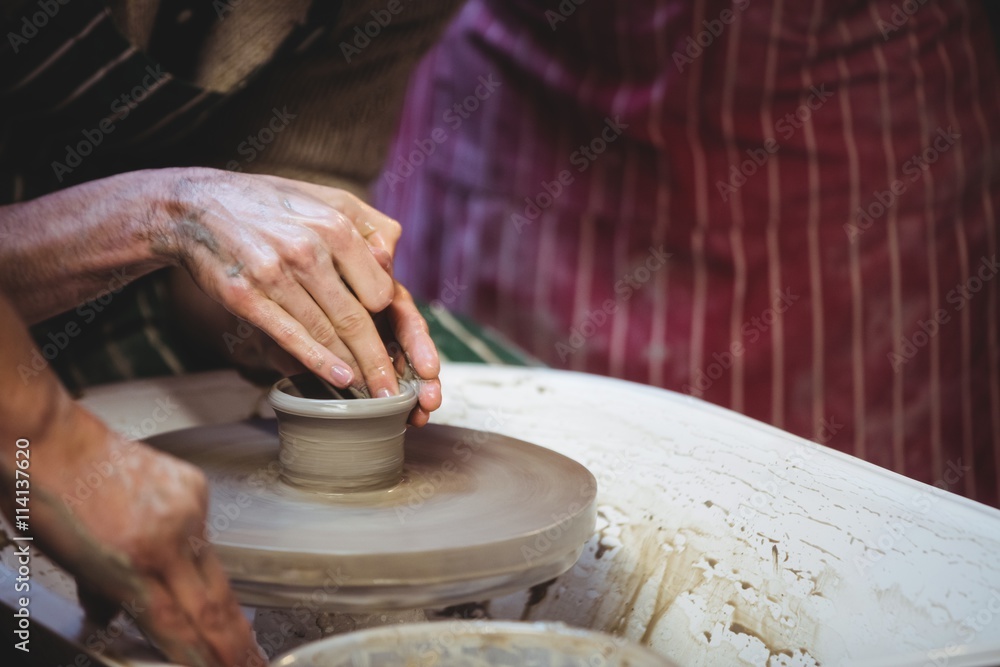 Artists working in pottery workshop