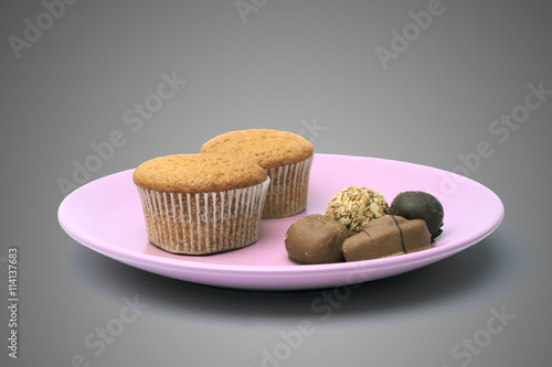 Dish with candy and cupcake