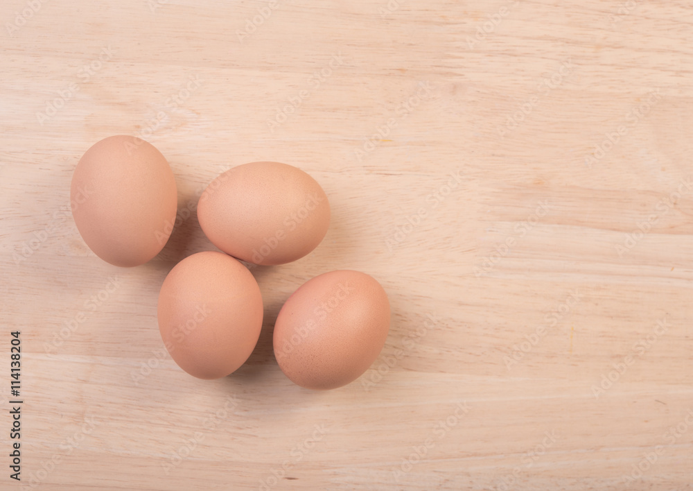 Fresh eggs ingredient on a wooden table rustic background.