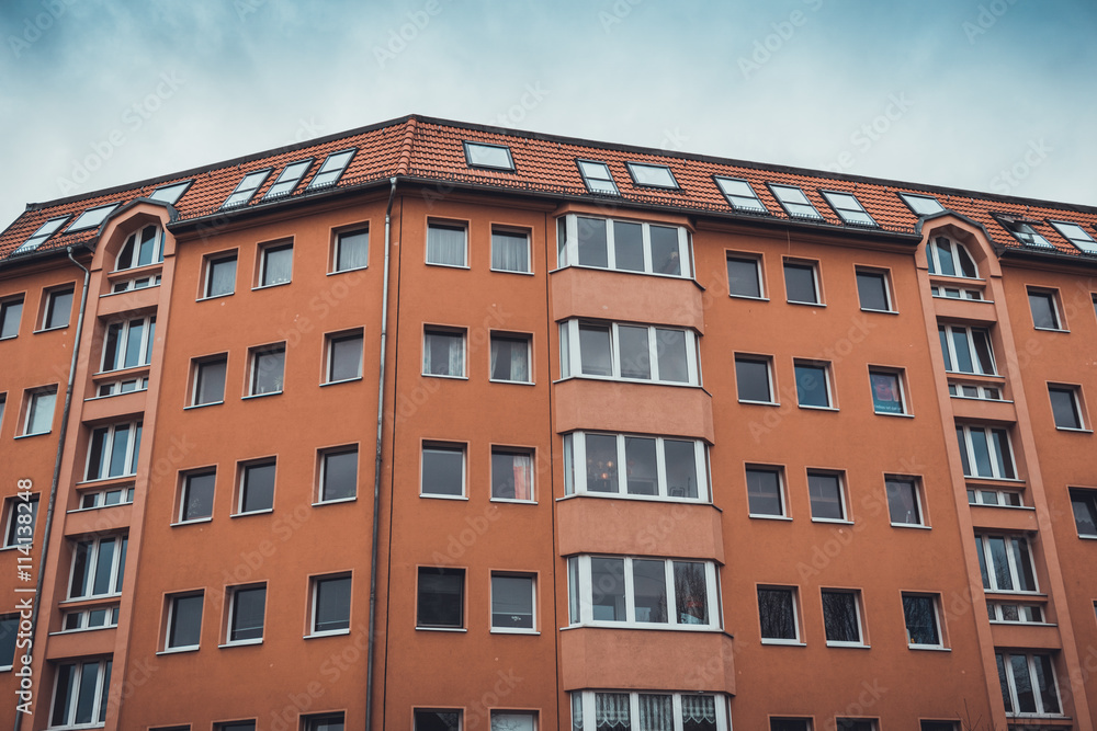 orange apartment building in a low angle view orange apartment building in a low angle view