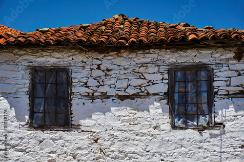 Windows in an old stone house in Greece. © GKor