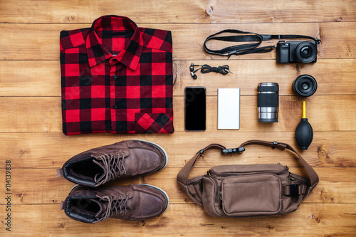 Travel concept boots, shirt, camera, mobilephone, bag, mp3,