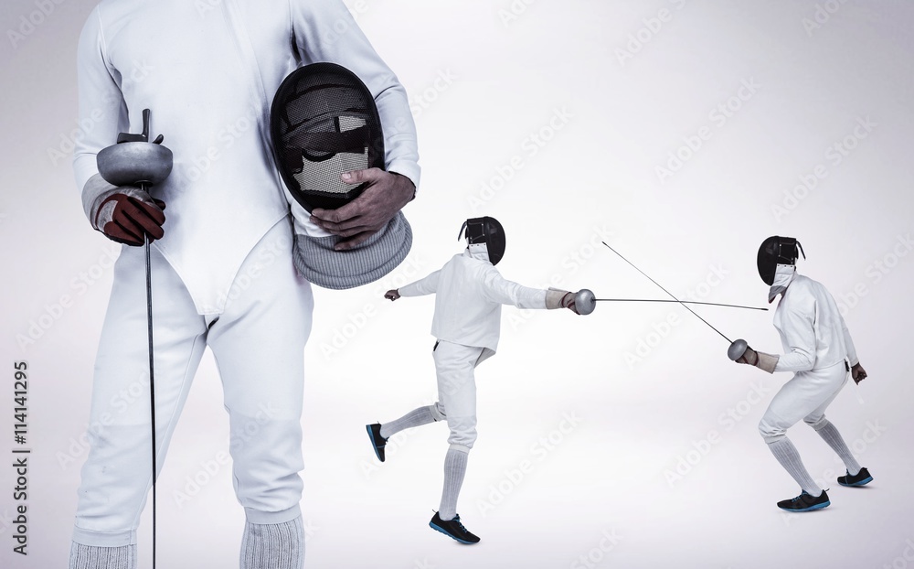 Composite image of swordsman holding fencing mask and sword