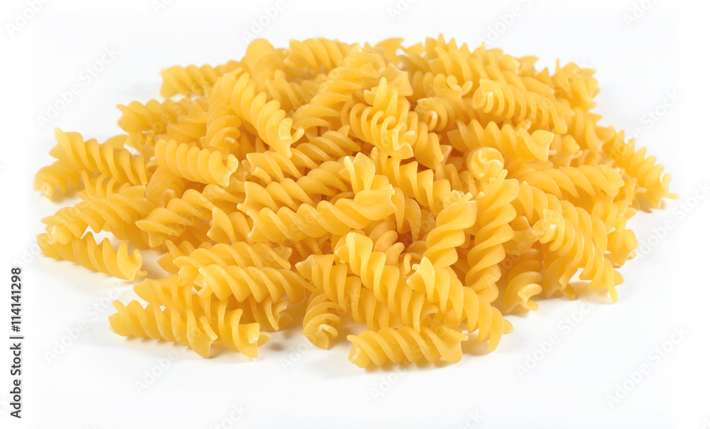 Heap of uncooked italian pasta fusilli on a white Heap of uncooked italian pasta fusilli on a white