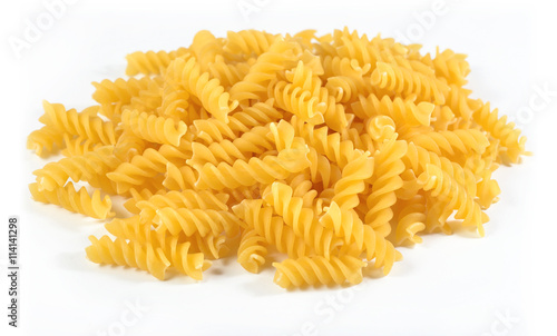 Heap of uncooked italian pasta fusilli on a white