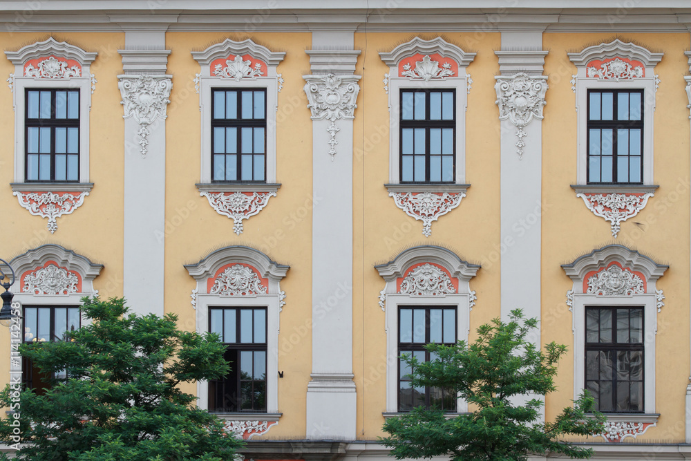 Beautiful building with arched windows and a bas-relief. Poland
