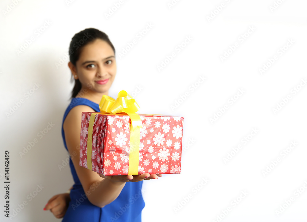 Beautiful young indian woman holding gift box Isolated on white Beautiful young indian woman holding gift box Isolated on white