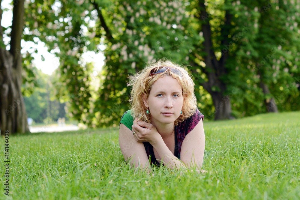Beautiful young woman resting in the park Beautiful young woman resting in the park