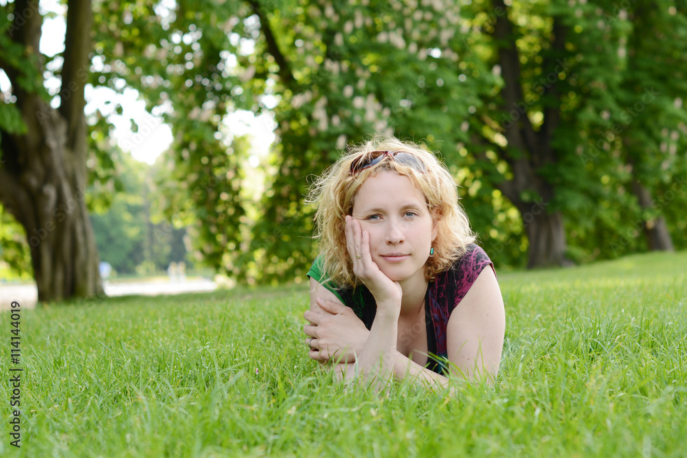 Beautiful young woman resting in the park Beautiful young woman resting in the park