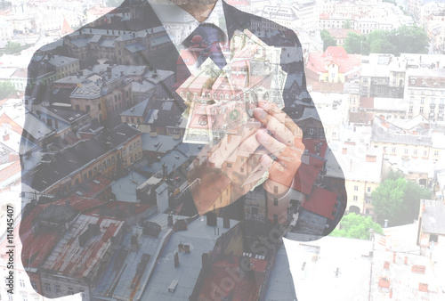 Man in suit holding money o...