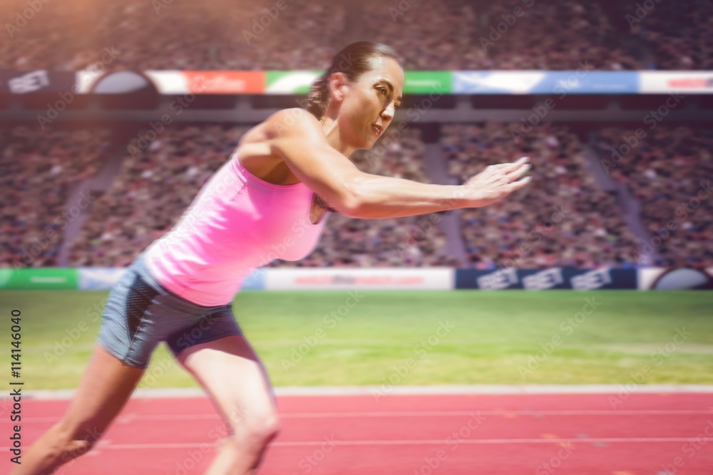 Composite image of an athletic woman starting to run 