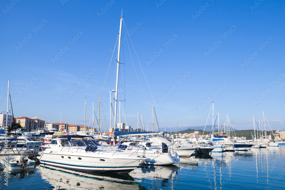 Sailing and motor yachts moored in port