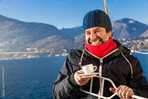 man makes a coffee break on sailboat